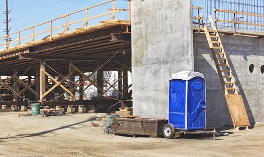 porta potties stacked at a busy construction site